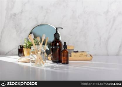 Different kinds of hygiene and cosmetic products near white marble wall in bathroom. Zero waste, eco friendly Natural cosmetic product for cleaning and care.