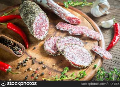 Different kinds of sausage on the wooden background
