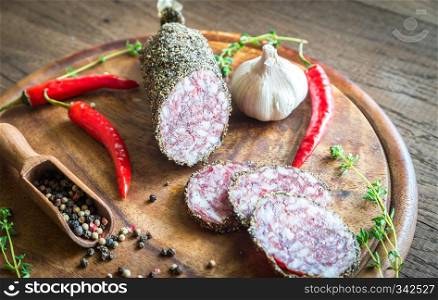 Different kinds of sausage on the wooden background