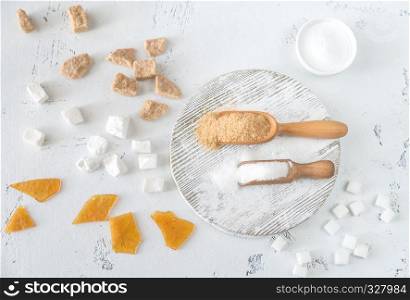 Different kinds of sugar on the wooden background