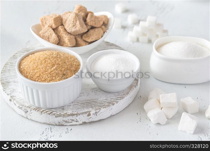 Different kinds of sugar on the wooden background