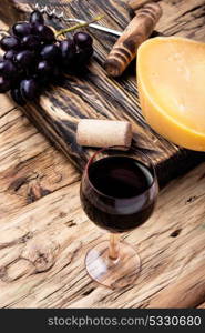 Different kinds of swiss cheeses. aromatic Swiss cheese and glass of grape wine