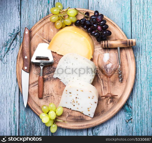 Different kinds of swiss cheeses. aromatic Swiss cheese and glass of grape wine