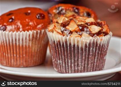 different muffins with fresh apples on white