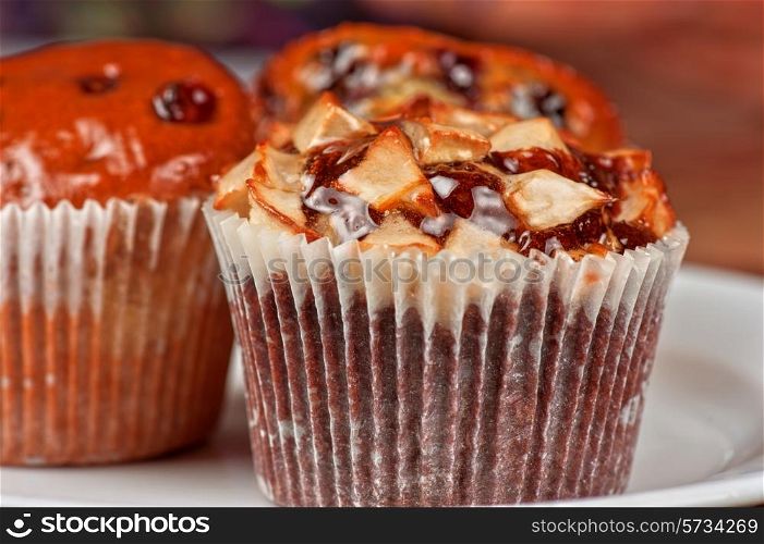 different muffins with fresh apples on white