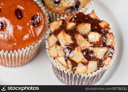 different muffins with fresh apples on white. muffins