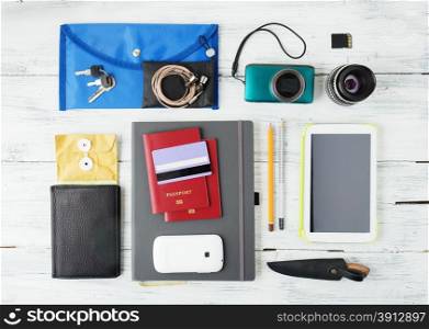 Different objects for traveling on wooden background