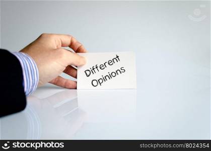 Different opinions note in business man hand