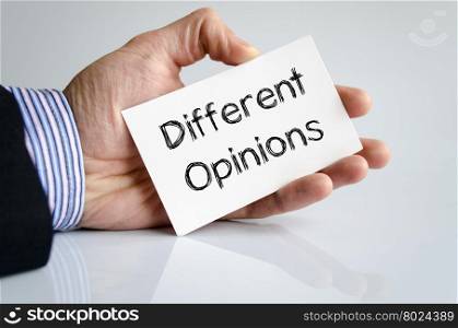 Different opinions note in business man hand