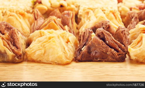 different oriental sweets baklava on wooden table. Oriental Sweet Baklava