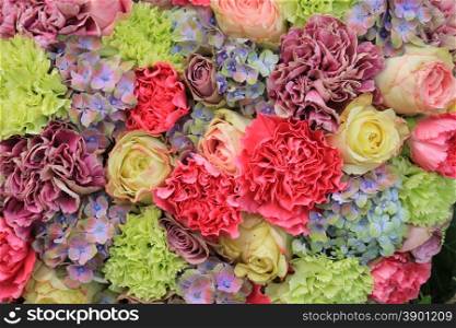 Different pastel flowers, carnations, roses and hydrangea in a pastel wedding arrangement