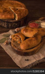 Different pies composition. Different pies from meat and vegetables. Freshly baked cakes on a table