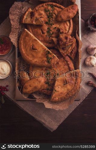 Different pies composition. Different pies from meat and vegetables. Freshly baked cakes on a table