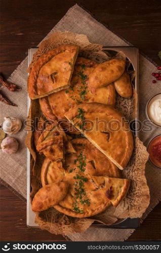 Different pies composition. Different pies from meat and vegetables. Freshly baked cakes on a table