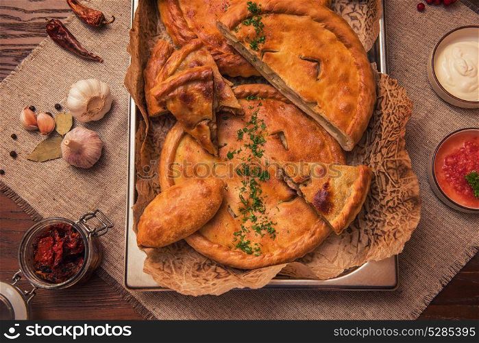 Different pies from meat and vegetables. Freshly baked cakes on a table. Different pies composition