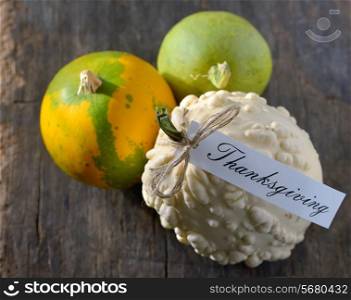 different pumpkins for Thanksgiving on old wooden background
