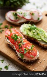 Different sandwiches with vegetables and microgreens. Healthy food