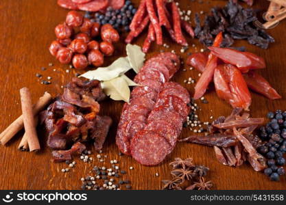 different sausage and meat on a celebratory table with spices and vegetables