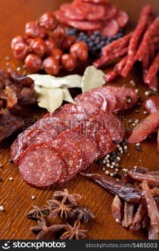 different sausage and meat on a celebratory table with spices and vegetables