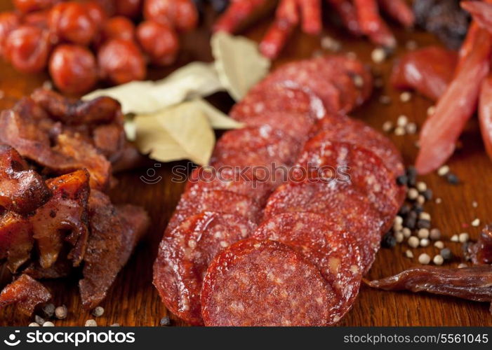 different sausage and meat on a celebratory table with spices and vegetables