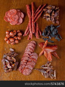 different sausage and meat on a celebratory table with spices and vegetables. meat and sausages