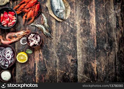 Different seafood in bowls. On a wooden background.. Different seafood in bowls.