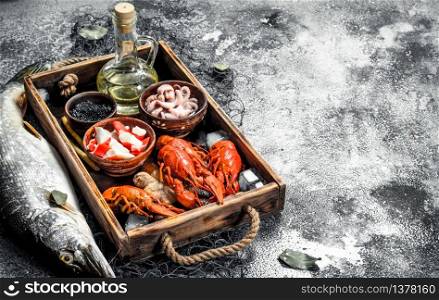 Different seafood on a wooden tray. On a rustic background.. Different seafood on a wooden tray.