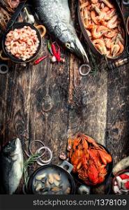 Different seafood on table. On a wooden background.. Different seafood on table.