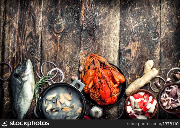 Different seafood on table. On a wooden background.. Different seafood on table.