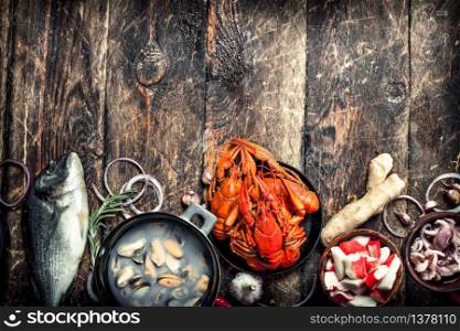 Different seafood on table. On a wooden background.. Different seafood on table.