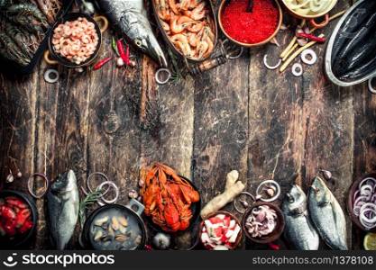 Different seafood with shrimps and red caviar. On a wooden background.. Different seafood with shrimps and red caviar.