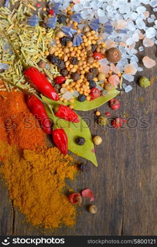 different Spices and herbs on old wood