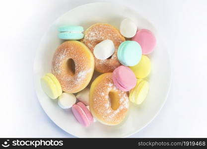 Different sweets isolated on white background, Doughnuts, macarons top view, unhealthy and candy concept copy space. Different sweets isolated on white background, Doughnuts, macarons top view, unhealthy and candy concept