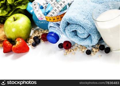 Different tools for sport and healthy food for diet on white background - sport, health and diet concept