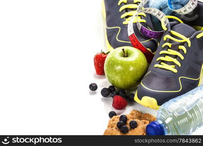 Different tools for sport and healthy food for diet on white background - sport, health and diet concept