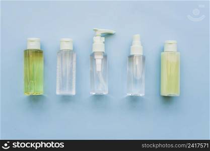 different type aloevera spray bottles blue background