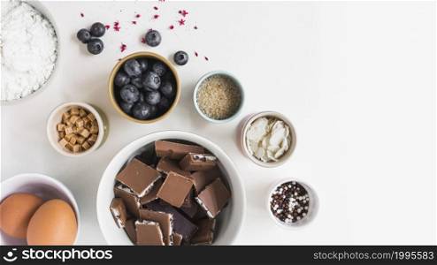 different type ingredients making cake white background