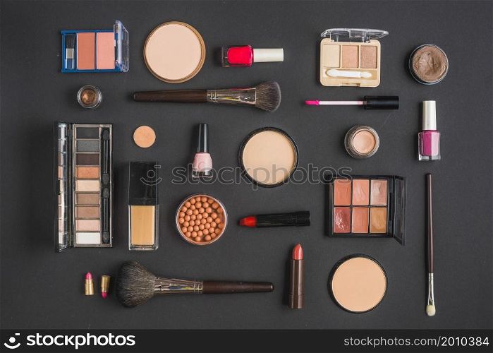 different type makeup products black backdrop