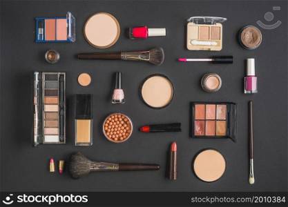 different type makeup products black backdrop