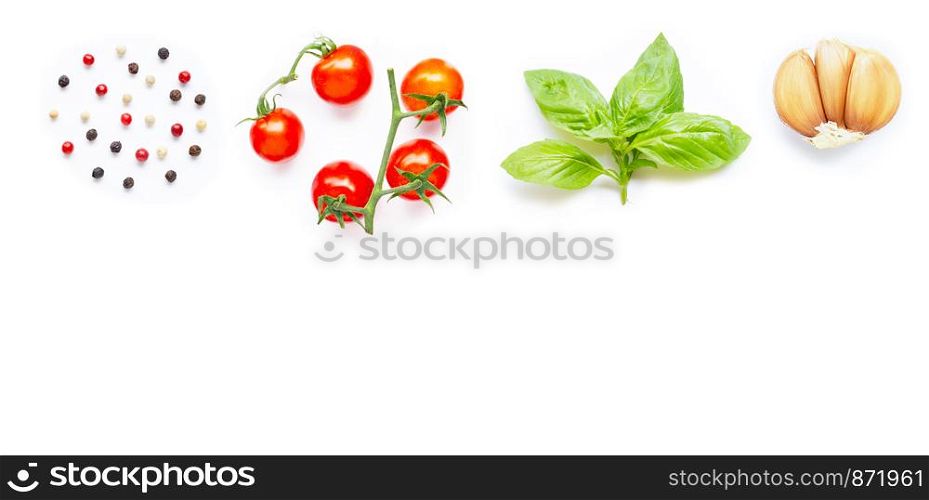 Different type of peppercorns, fresh cherry tomatoes, basil leaves and garlic on white background. Copy space