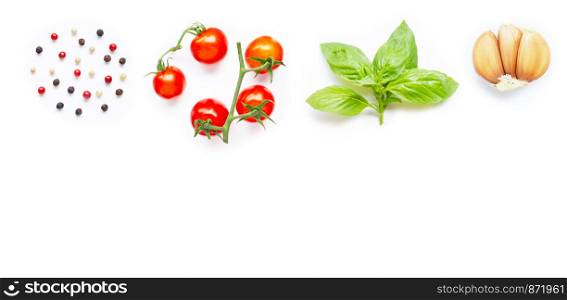 Different type of peppercorns, fresh cherry tomatoes, basil leaves and garlic on white background. Copy space