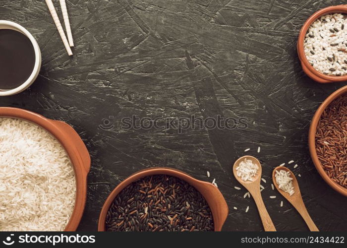 different type rice grains bowl with soya sauce chopsticks wooden spoon