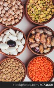 Different types of beans in wooden bowls. Types of beans