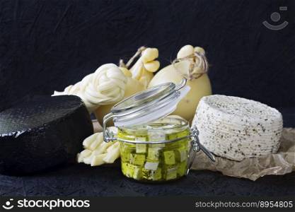 Different types of cheese on a black background. Cheese platter.. Different types of cheese on a black background. Cheese platter