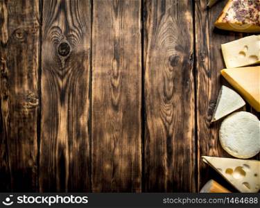 Different types of cheese . On a wooden table.. Different types of cheese .