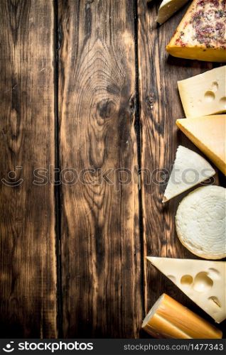 Different types of cheese . On a wooden table.. Different types of cheese .