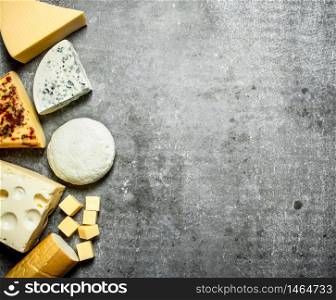 Different types of cheese. On the stone table.. Different types of cheese. On stone table.