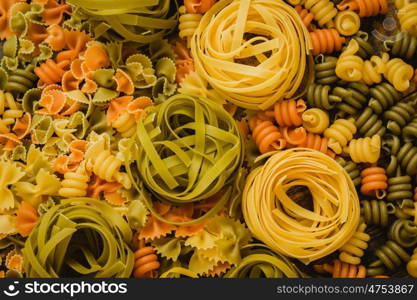 Different types of colored pasta with various shapes