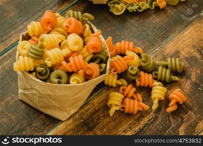 Different types of colored pasta with various shapes