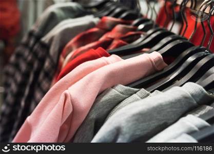 Different types of colorful clothes on hangers